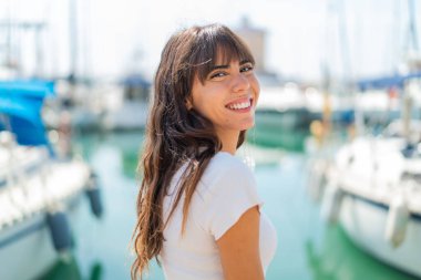 Açık havada genç bir kadın Neşeli bir ifadeyle