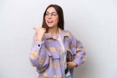 Young girl isolated on white background pointing to the side to present a product