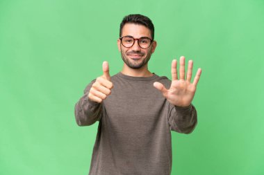 İzole edilmiş geçmişi olan yakışıklı beyaz bir adam. Parmakları olan altı kişi saydım.