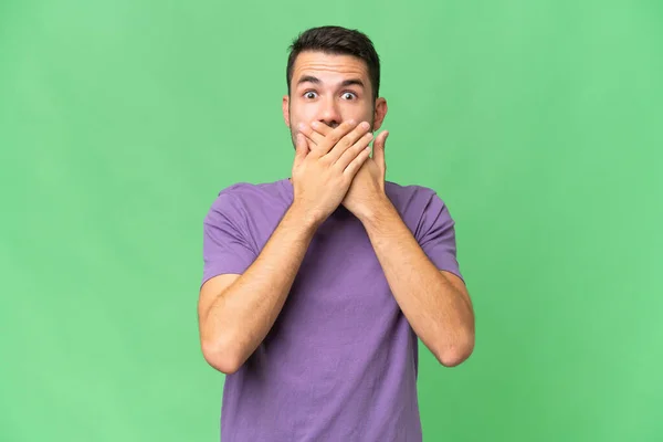 stock image Young handsome caucasian man over isolated background covering mouth with hands