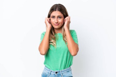 Young Uruguayan woman isolated on white background frustrated and covering ears