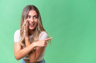 Genç Uruguaylı kadın bir ürünü sunmak ve bir şeyler fısıldamak için kenarı işaret ediyor.