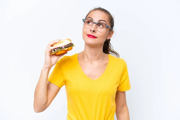 Young Caucasian Woman Holding Burger Isolated White Background Looking — 图库照片