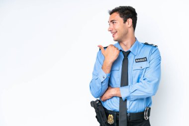 Young police caucasian man isolated on white background pointing to the side to present a product
