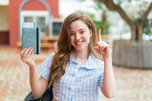 Young Redhead Woman Holding Passport Outdoors Pointing Great Idea — Stock Photo, Image