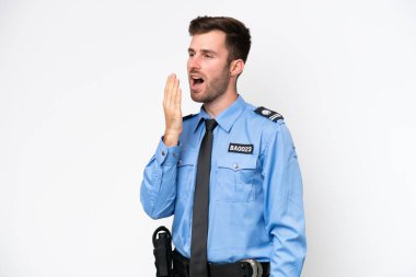 Young police caucasian man isolated on white background yawning and covering wide open mouth with hand