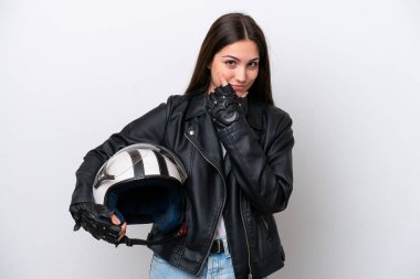 Young girl with a motorcycle helmet isolated on white background having doubts
