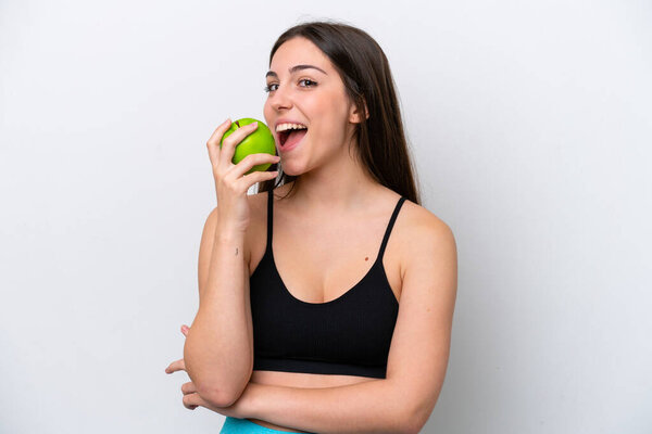 Young girl isolated on white background eating an apple