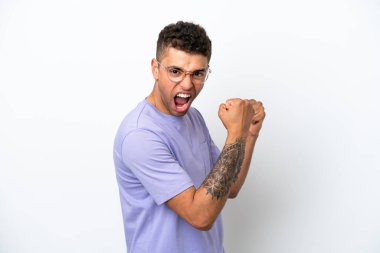 Young caucasian Brazilian man isolated on white background celebrating a victory