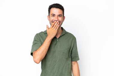 Young handsome man over isolated white background happy and smiling covering mouth with hand
