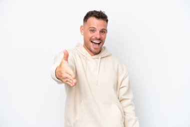 Beyaz arka planda izole edilmiş beyaz tenli yakışıklı adam iyi bir anlaşma için el sıkışıyor.