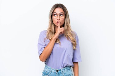 Young Uruguayan woman isolated on white background showing a sign of silence gesture putting finger in mouth