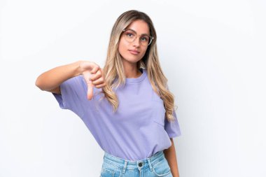 Young Uruguayan woman isolated on white background showing thumb down with negative expression