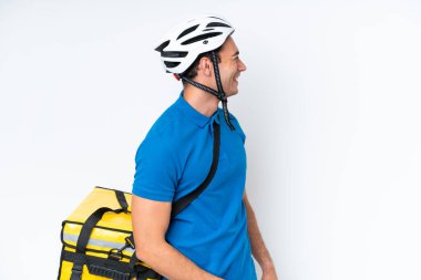 Beyaz arka planda izole edilmiş termal sırt çantalı beyaz bir adam yan yana gülüyor.