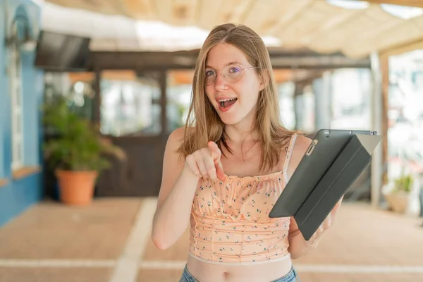 Franska Flicka Med Glasögon Håller Tablett Utomhus Förvånad Och Pekar — Stockfoto
