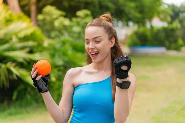 Dışarıda Elinde Portakal Tutan Genç Güzel Bir Kız Zaferi Kutluyor — Stok fotoğraf