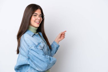 Young Brazilian woman isolated on white background pointing finger to the side