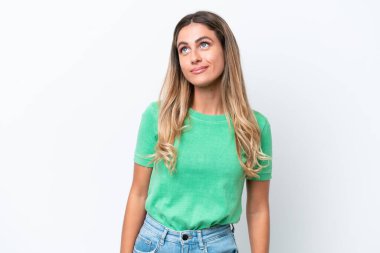 Young Uruguayan woman isolated on white background thinking an idea while looking up