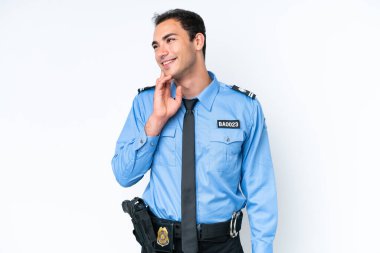 Young police caucasian man isolated on white background thinking an idea while looking up