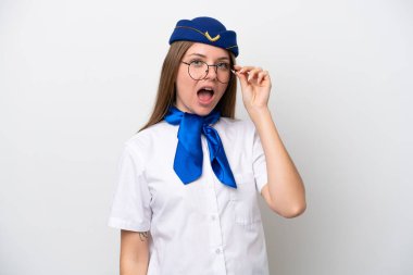 Litvanyalı uçak hostesi beyaz arka planda gözlüklü ve şaşırmış.