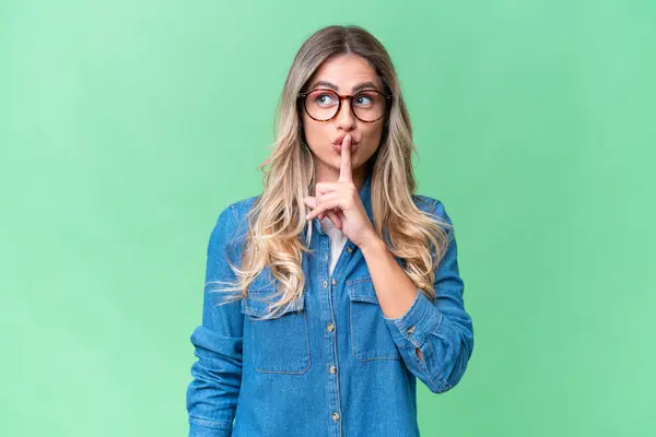 stock image Young Uruguayan woman over isolated background showing a sign of silence gesture putting finger in mouth