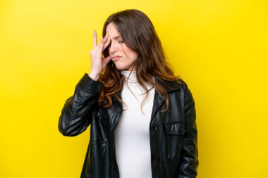 Sarı arka planda izole edilmiş, başı ağrıyan beyaz bir kadın.