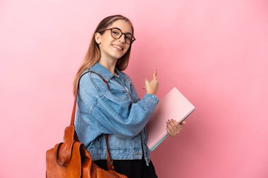 Pembe arka planda izole edilmiş genç beyaz kadın.