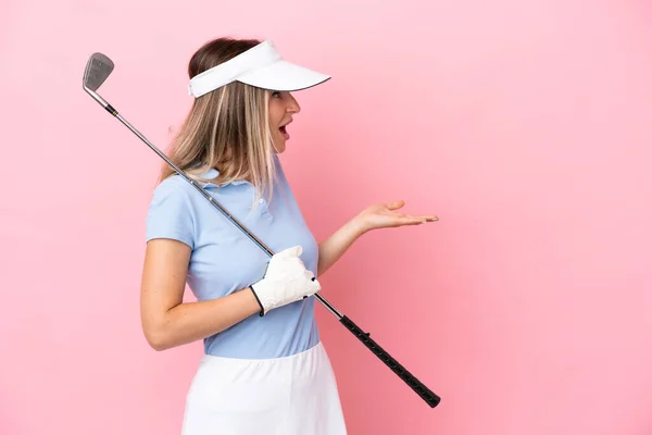 Młoda Golfistka Kobieta Odizolowana Różowym Tle Ekspresją Zaskoczenia Patrząc Bok — Zdjęcie stockowe