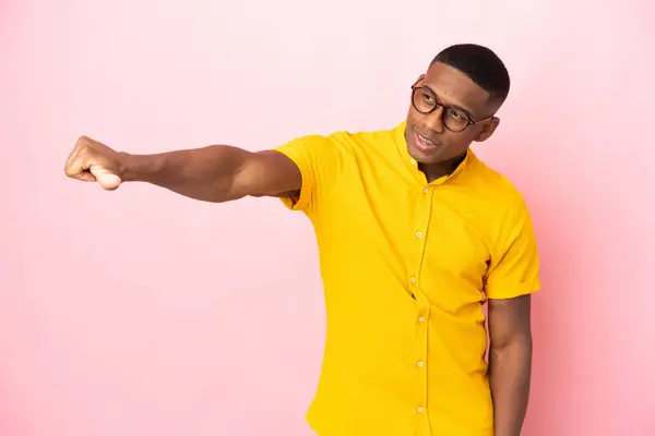 stock image Young latin man isolated on pink background giving a thumbs up gesture