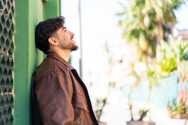 Açık havada yakışıklı bir Arap.