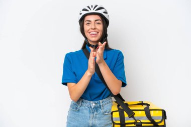 Young caucasian woman with thermal backpack isolated on white background applauding after presentation in a conference