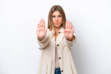 Young caucasian woman isolated on white bakcground making stop gesture and disappointed