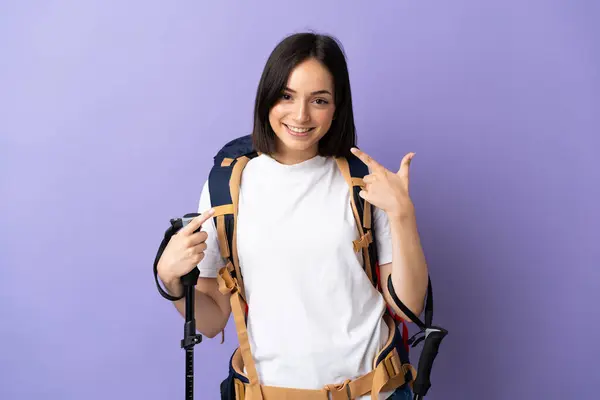 Young Caucasian Woman Backpack Trekking Poles Isolated Blue Background Giving — Stock Photo, Image