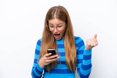 Beyaz arka planda izole genç beyaz kadın şaşırdı ve bir mesaj gönderiyor.