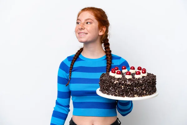 Young Reddish Woman Holding Birthday Cake Isolated White Background Thinking — Zdjęcie stockowe