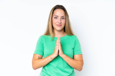Beyaz arka planda izole edilmiş genç beyaz kadın avuç içlerini bir arada tutuyor. İnsan bir şey ister.