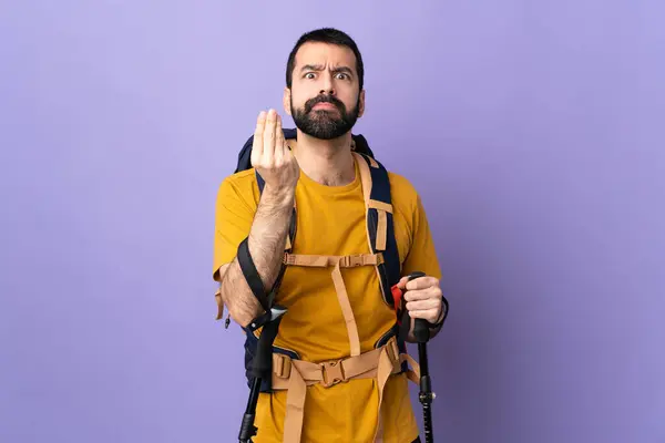 stock image Caucasian handsome man with backpack and trekking poles over isolated background making Italian gesture