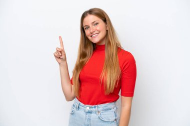 Beyaz arka planda izole edilmiş genç beyaz kadın en iyinin işareti olarak parmağını kaldırıyor ve gösteriyor.