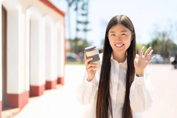 Bonita Mujer China Sosteniendo Café Para Llevar Aire Libre Saludando — Foto de Stock