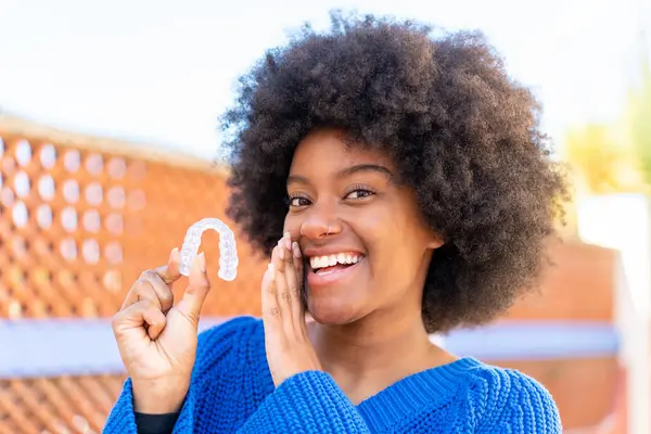 African American Girl Holding Invisible Braces Outdoors Whispering Something — Stock Photo, Image