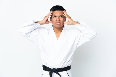 Beyaz arka planda karate yapan genç Ekvadorlu adam sürpriz bir ifadeyle izole edilmiş.