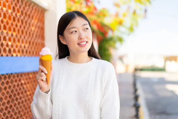 Pretty Chinese Woman Cornet Ice Cream Outdoors Looking While Smiling — Stock Photo, Image