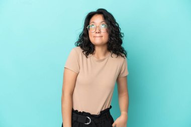 Asyalı genç bir kadın mavi arka planda izole edilmiş.