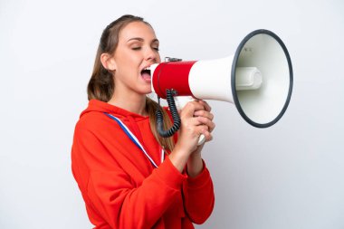 Young caucasian woman with medals isolated on white background shouting through a megaphone