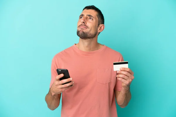 Young Handsome Caucasian Man Isolated Blue Background Buying Mobile Credit — Stock Photo, Image