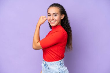Young woman isolated on purple background doing strong gesture