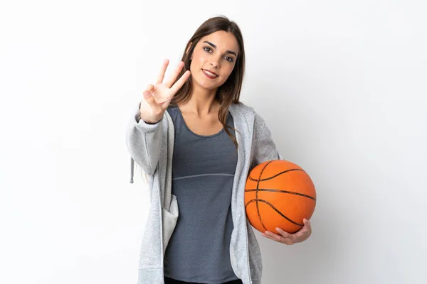 Молодая Женщина Играющая Баскетбол Изолированы Белом Фоне Счастливы Подсчет Трех — стоковое фото