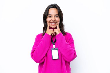 Beyaz arka planda izole edilmiş, mutlu ve hoş bir ifadeyle gülümseyen genç İspanyol kadın.