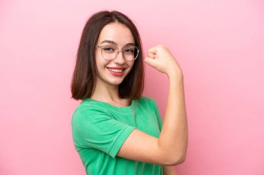 Genç Ukraynalı bir kadın pembe arka planda gözlüklü ve zaferi kutluyor.