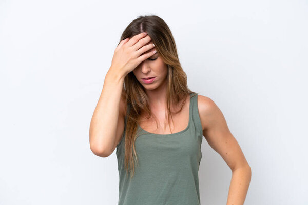 Young caucasian woman isolated on white background with headache